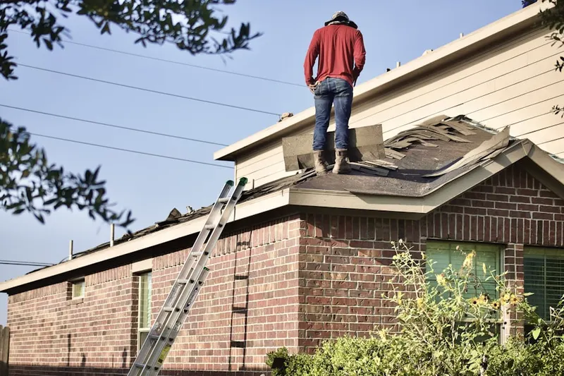 Professional roofer working on a residential roof in Knollview